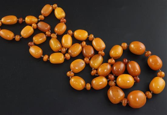 A single strand graduated amber bead necklace, 122cm